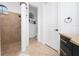 Neutral-tiled shower and commode area featuring elegant arches in a well-appointed bathroom at 8437 Lake Burden Cir, Windermere, FL 34786