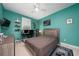 Bedroom featuring bright walls, floating shelving, a desk with two monitors, and a ceiling fan at 8437 Lake Burden Cir, Windermere, FL 34786