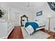 Bright bedroom featuring a white bed, wood floors, a full length mirror, and a ceiling fan at 8437 Lake Burden Cir, Windermere, FL 34786