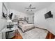 Primary bedroom suite with wood floors, a ceiling fan, an area rug, and shuttered windows at 8437 Lake Burden Cir, Windermere, FL 34786