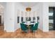 A dining area with modern chairs, marble table, ceramic tile flooring, and a decorative light fixture at 8437 Lake Burden Cir, Windermere, FL 34786