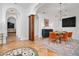 Elegant dining room with modern lighting, tile floors, and arched entryways at 8437 Lake Burden Cir, Windermere, FL 34786