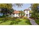 Charming Mediterranean-style home with lush landscaping and a well-manicured lawn at 8437 Lake Burden Cir, Windermere, FL 34786