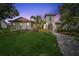 Charming Mediterranean-style home with lush landscaping, a tile roof, and a brick walkway at 8437 Lake Burden Cir, Windermere, FL 34786