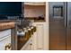 Kitchen stove with stainless steel appliances, granite countertops, custom cabinetry, and tan ceramic tile flooring at 8437 Lake Burden Cir, Windermere, FL 34786