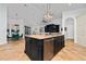 A spacious kitchen with a large island, granite countertops, stainless steel appliances, and tan ceramic tile flooring at 8437 Lake Burden Cir, Windermere, FL 34786