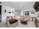 Bright living room with a large sofa, round coffee table, and sliding glass doors at 8437 Lake Burden Cir, Windermere, FL 34786