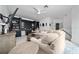 Cozy living room with a large sectional sofa, built-in shelving, and a ceiling fan at 8437 Lake Burden Cir, Windermere, FL 34786