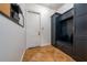 A mud room with built-in storage and a bench seating, ceramic tile flooring and a white door at 8437 Lake Burden Cir, Windermere, FL 34786