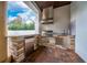 Outdoor kitchen features stainless steel appliances and a convenient bar area at 8437 Lake Burden Cir, Windermere, FL 34786