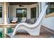 Outdoor pool area featuring patio furniture, a covered patio, and a stylish white lounge chair at 8437 Lake Burden Cir, Windermere, FL 34786