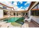 A beautiful pool area, courtyard with patio seating, red tile roof, and white stucco walls at 8437 Lake Burden Cir, Windermere, FL 34786