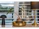 Stylish interior detail with a black lamp and a plant displayed in front of window shutters at 8437 Lake Burden Cir, Windermere, FL 34786