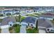 A view of neighborhood homes with solar panels on the roofs and fenced-in back yards at 9158 Elsa Ct, Davenport, FL 33897