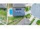 An aerial view shows solar panels, a pool, and green space in the backyard of this home at 9158 Elsa Ct, Davenport, FL 33897