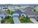 Aerial view of a single-Gathering home with a blue garage door, stone accents, and decorative driveway at 9158 Elsa Ct, Davenport, FL 33897