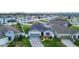 Aerial view of a single-Gathering home with a blue garage door, stone accents, and decorative landscaping at 9158 Elsa Ct, Davenport, FL 33897