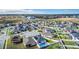 Community aerial view with a pool, solar panels, and neighborhood layout, showcasing the available amenities at 9158 Elsa Ct, Davenport, FL 33897