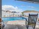 Private backyard oasis featuring a sparkling pool and decorative landscaping at 9158 Elsa Ct, Davenport, FL 33897