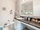 Bright bathroom featuring granite countertops, vanity, and shower with glass doors at 9158 Elsa Ct, Davenport, FL 33897