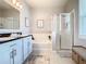 Bright bathroom featuring a double vanity, soaking tub, and a glass-enclosed shower at 9158 Elsa Ct, Davenport, FL 33897