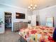 Bedroom featuring bedside tables and lamps, as well as a walk-in closet at 9158 Elsa Ct, Davenport, FL 33897