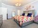 Bedroom featuring bedside tables and lamps, as well as flower decorations on the wall at 9158 Elsa Ct, Davenport, FL 33897
