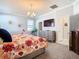 Bedroom with a flat-screen TV and a dresser between the bathroom and the other bedroom at 9158 Elsa Ct, Davenport, FL 33897