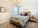 Bedroom with a warm color palette, a nightstand, and decor accents at 9158 Elsa Ct, Davenport, FL 33897