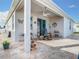 Relaxing covered patio with tile flooring, ceiling fan, and comfortable seating, ideal for enjoying outdoor living at 9158 Elsa Ct, Davenport, FL 33897