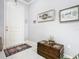 Inviting entryway with decor on the walls and a decorative trunk with a ship on it at 9158 Elsa Ct, Davenport, FL 33897