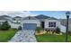 Charming single-Gathering home with a blue garage door, stone accents, and decorative driveway at 9158 Elsa Ct, Davenport, FL 33897