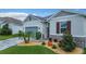 Close up of a single-Gathering home showing its blue garage door, stone accents, and landscaping at 9158 Elsa Ct, Davenport, FL 33897