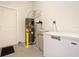 Garage area featuring a water heater and additional storage space at 9158 Elsa Ct, Davenport, FL 33897