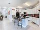 Open concept kitchen features an island with seating and seamless flow to adjacent areas at 9158 Elsa Ct, Davenport, FL 33897