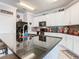 Kitchen with granite countertops, an island, black appliances and ample cabinet space at 9158 Elsa Ct, Davenport, FL 33897