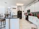 Modern kitchen featuring an island with barstool seating and black appliances at 9158 Elsa Ct, Davenport, FL 33897