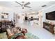 Bright, open living area with an island kitchen, comfortable seating, and a view of the dining area at 9158 Elsa Ct, Davenport, FL 33897
