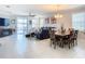 Inviting living room featuring tile flooring, comfortable seating, and natural light at 9158 Elsa Ct, Davenport, FL 33897