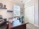 Home office featuring a spacious desk, neutral tones, and closet space for a productive workspace at 9158 Elsa Ct, Davenport, FL 33897