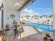 Inviting pool area featuring a covered patio, tile flooring, and a sparkling pool perfect for relaxation and entertaining at 9158 Elsa Ct, Davenport, FL 33897