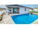 Sparkling swimming pool with a covered patio, perfect for outdoor entertaining and relaxation at 9158 Elsa Ct, Davenport, FL 33897