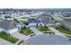An aerial street view of well-maintained homes featuring attractive landscaping and paved driveways at 9158 Elsa Ct, Davenport, FL 33897