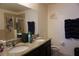 Bathroom featuring double sinks, granite countertops, and decorative elements at 1217 Honey Blossom Dr, Orlando, FL 32824