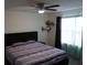 Relaxing bedroom features a ceiling fan, shelf, and light-filtering curtains at 1217 Honey Blossom Dr, Orlando, FL 32824