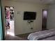 Bright bedroom with closet space, TV, and adjoining bath at 1217 Honey Blossom Dr, Orlando, FL 32824