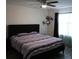 Relaxing bedroom features a ceiling fan, shelf, and light-filtering curtains at 1217 Honey Blossom Dr, Orlando, FL 32824