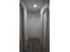 Neutral hallway with doors and gray-stained wood laminate flooring at 1217 Honey Blossom Dr, Orlando, FL 32824