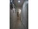 Hallway with light tile flooring and white brick accent wall that leads to the front door at 1217 Honey Blossom Dr, Orlando, FL 32824