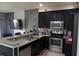 Modern kitchen with granite countertops, dark cabinetry, stainless steel appliances and bar seating at 1217 Honey Blossom Dr, Orlando, FL 32824